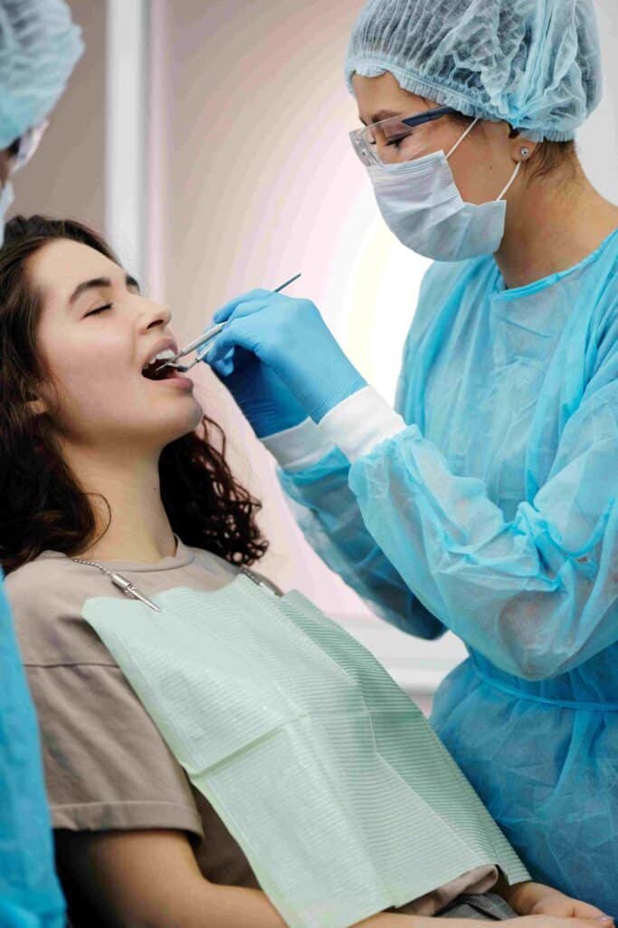 Dentist examining a patient during a same-day emergency visit in Frisco TX